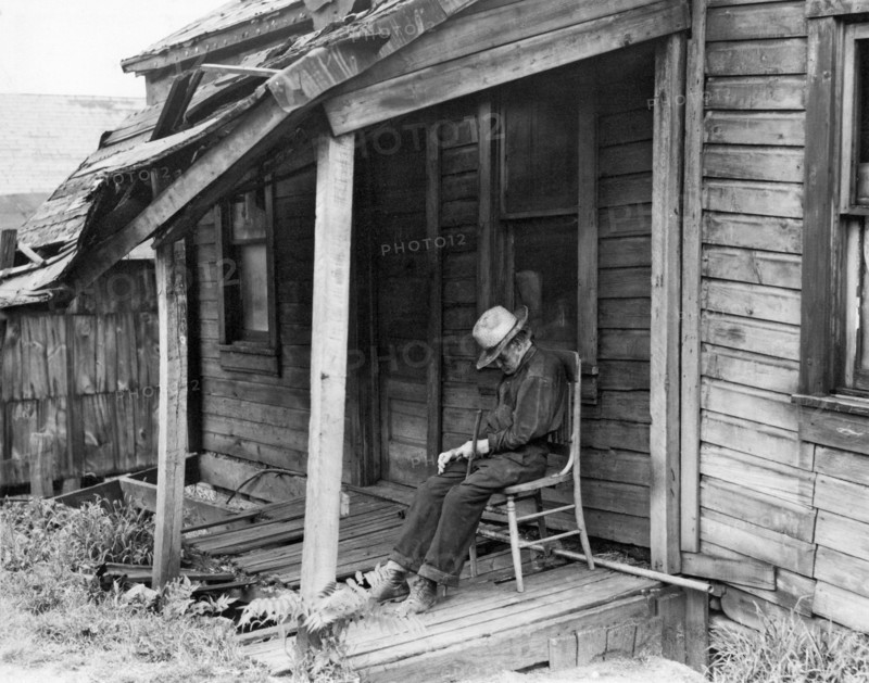 Elderly Man Doses On His Porch