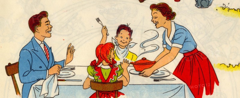 Family at Table as Mom serves hot food