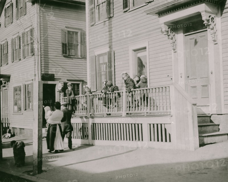 Exterior of Sprague House Settlement Providence, on Saturday morning. The house was so full that these children could not go in.  1912