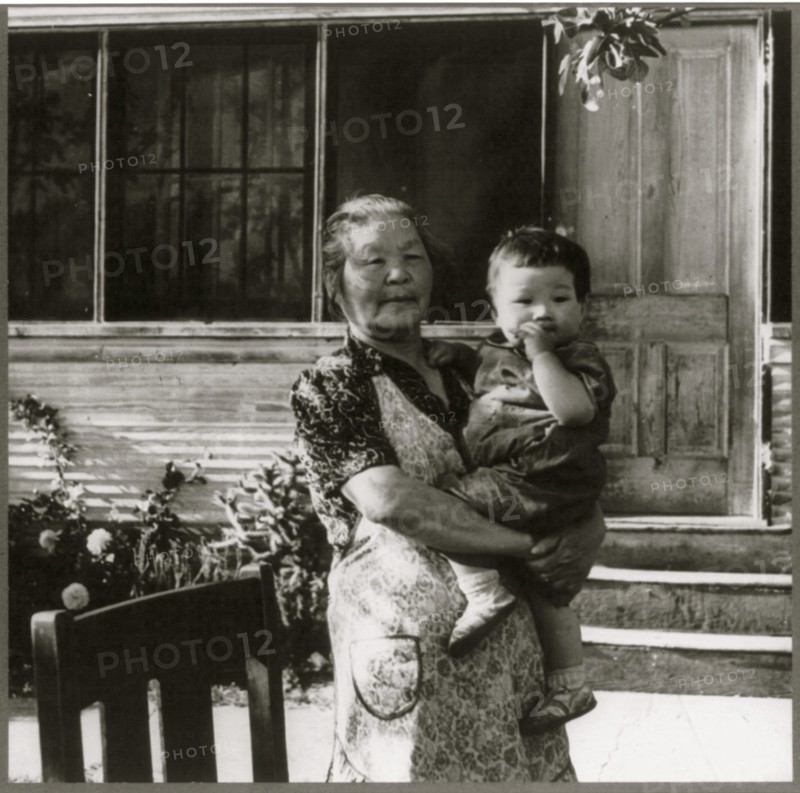 Grandmother Hold Baby in evacuation to Manzanar 1942