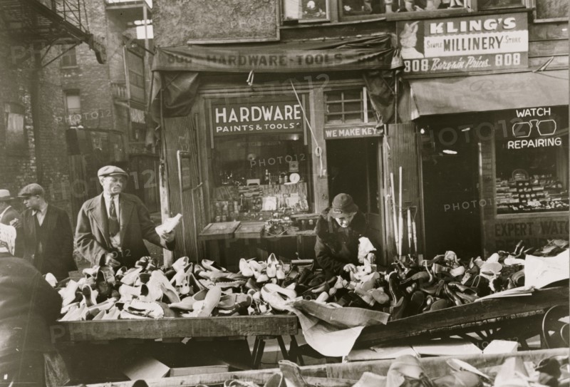 People shopping for shoes at shop on Maxwell Street, Chicago, Illinois 1941