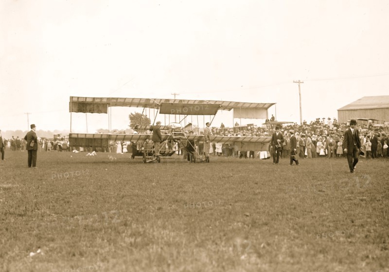 Harmon in aeroplane with crowds of onlookers