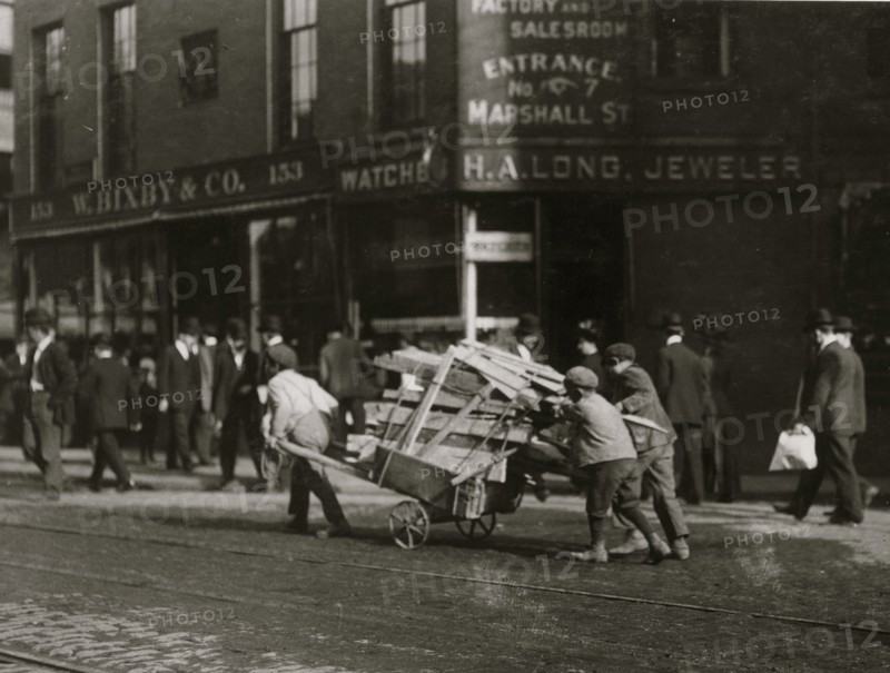 3 Boy Woodpickers Under Way lugging a cart full of firewood. 1909