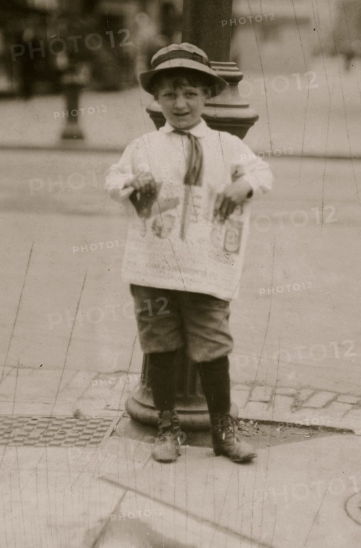 6 yr. old Earle Holt (or Hope) sells papers for a neighbor boy.  1912
