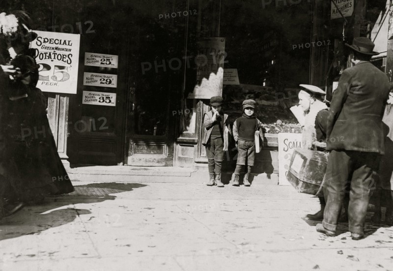 7 year old twins selling newspapers in front of newsstand 1909