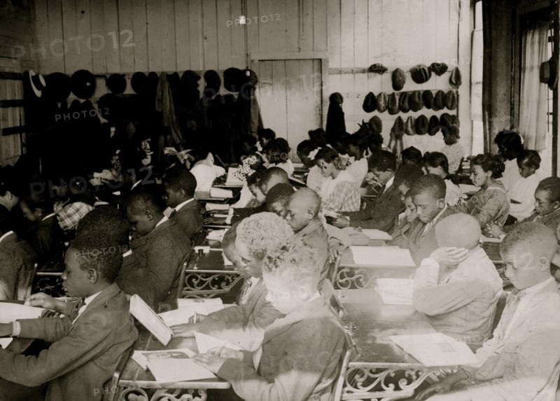 75 Sixth Grade African American children  crowded into 1 small room in an old store building near Black High School, with 1 teacher. 1917