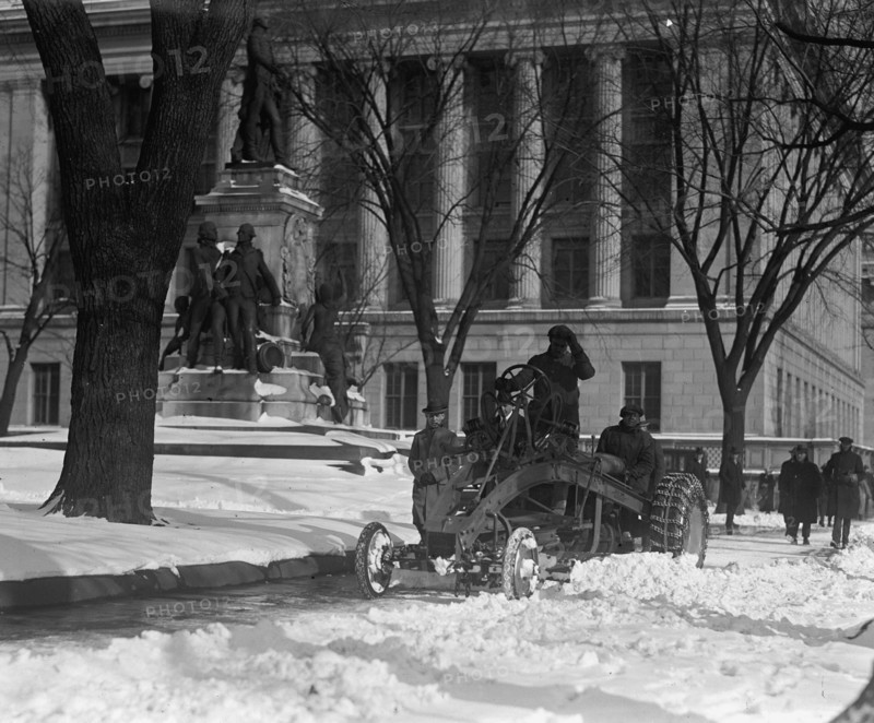 A Ford Tractor cleans snow on DC Street 1924
