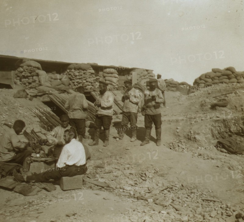 A soldier-cobbler mending boots in a Russian redoubt  1905