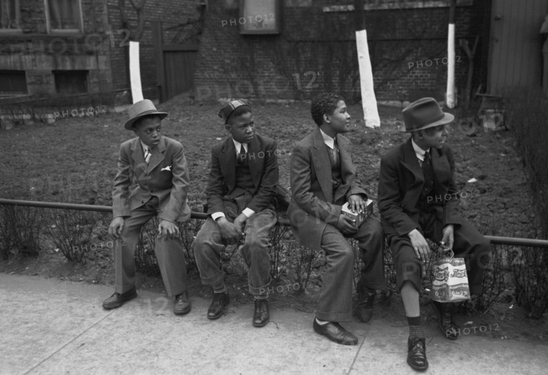 African American Boys waiting outside of Episcopal Church to see the processional, South Side of Chicago, Illinois 1938
