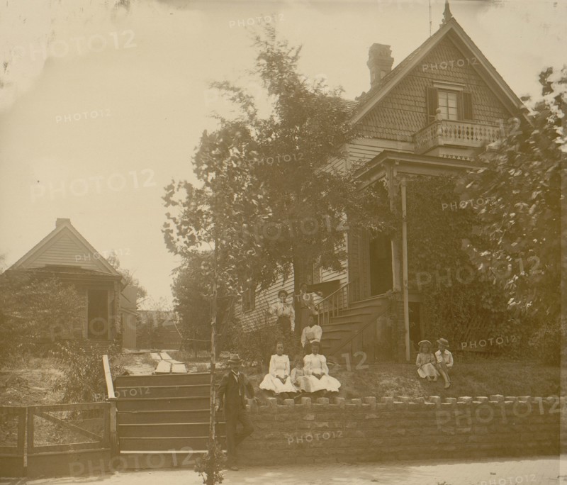 African American family posed on porch of house 1899