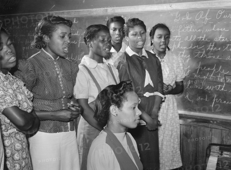 African American in Music class practicing songs for May Day-Health Day festivities. Flint River Farms, Georgia 1939