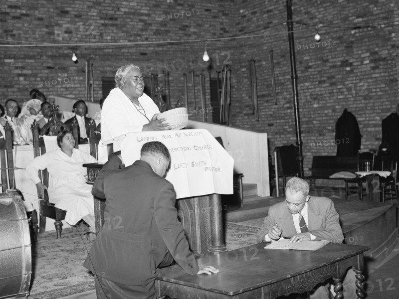 African American Woman Pastor leads her congregation in Prayer 1941
