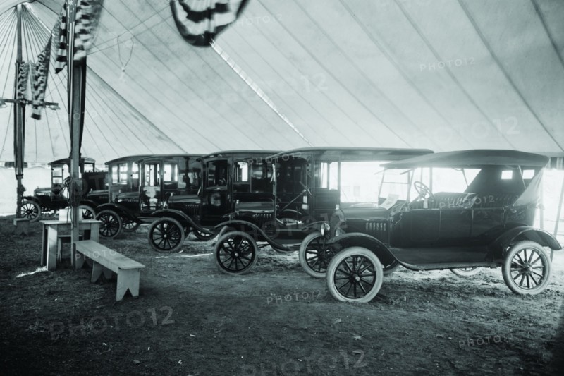 Automobiles on Display in Tent Under American Flag Banners 1921