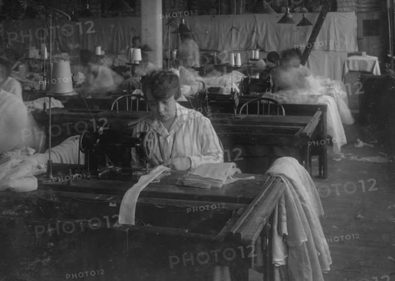 Bessie Blitch, 15 years old. Sewing curtains on machine at Boutwell, Fairclough & Gold, 274 Summer Street Extension. 1917