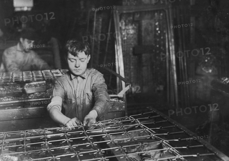 Boys "linking" bed-springs. 14 and 15 years old. 1917