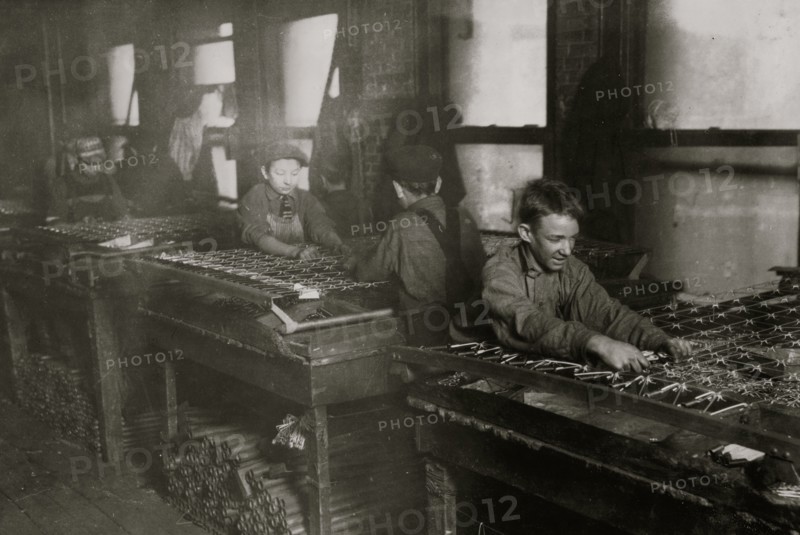 Boys "linking" bed-springs. 14 and 15 years old. 1917