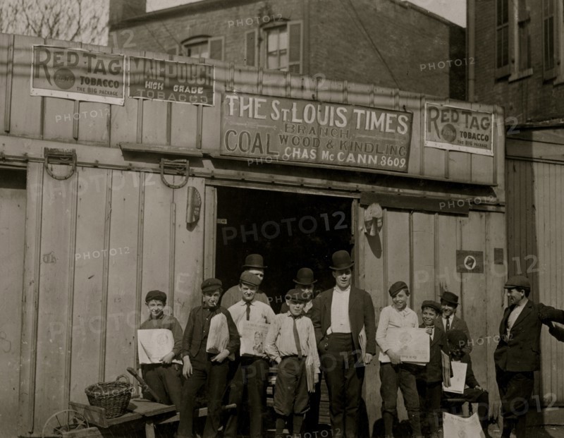 Boys wait outside of a Coal Shed Office that also serves as a depot for the newsboys to pickup their papers i.e. the St. Louis Times 1910