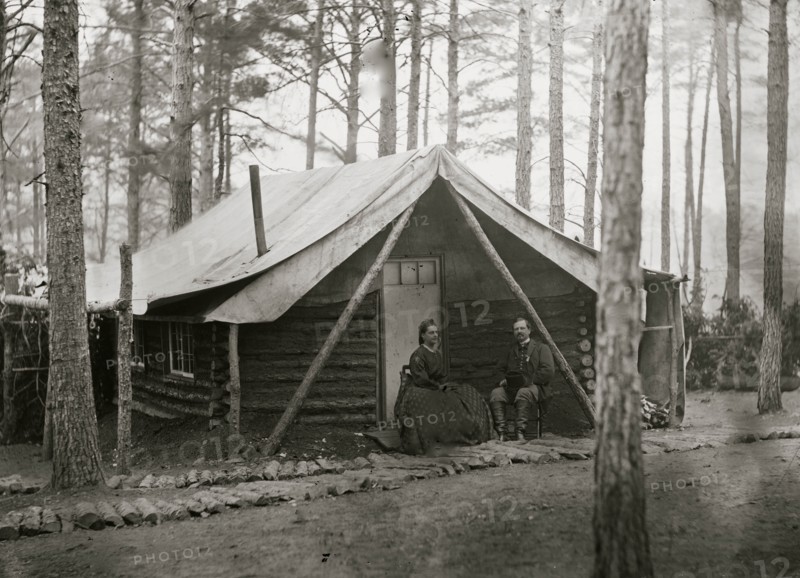 Brandy Station, Virginia. Col. John R. Coxe, A.C.S., and lady seated before his log-cabin winter quarters at Army of the Potomac headquarters 1864