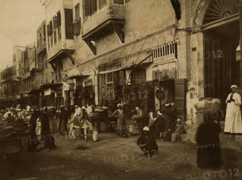 Busy commercial street in Cairo. 1880