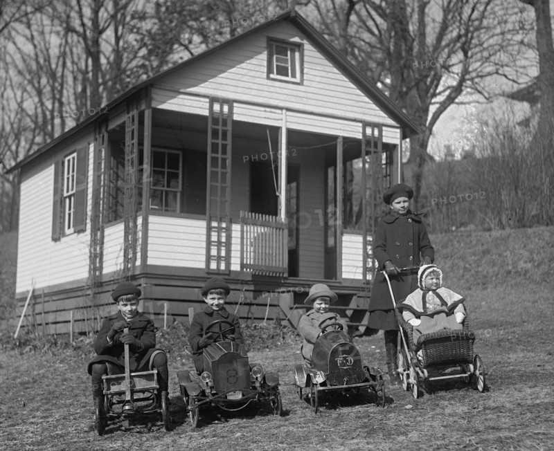 Children line up on lawn with they Toy cars, each driving them 1924