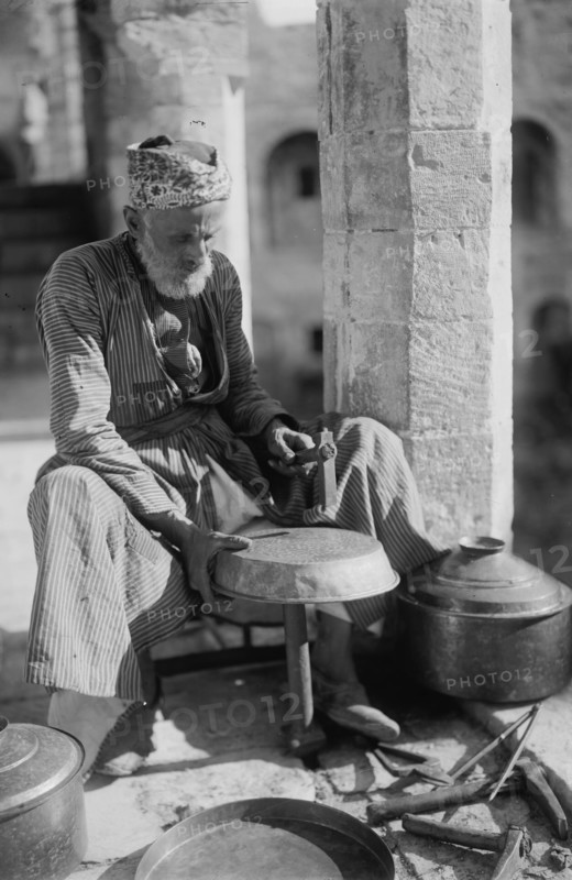Coppersmith Hammers a Pot into shape 1930