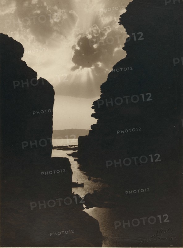 Dead Sea Sun Breaks the Clouds as Seen Thorugh the Stone Walls of the Amon Gorge 1920
