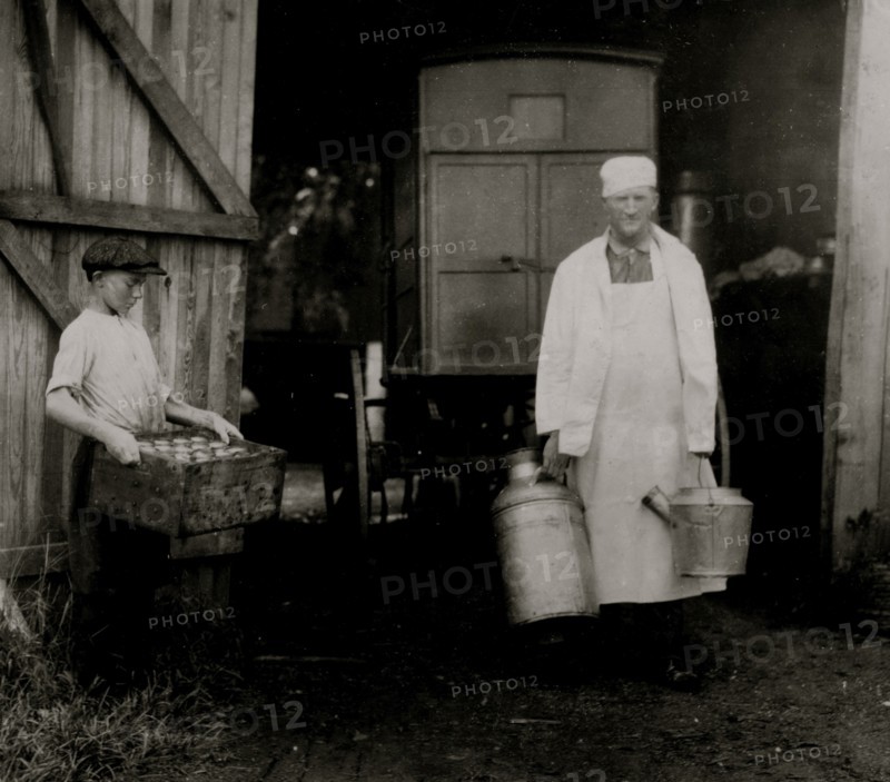 Loading Mill and other Dairy products from the farm into the wagon driven by a young man 1916