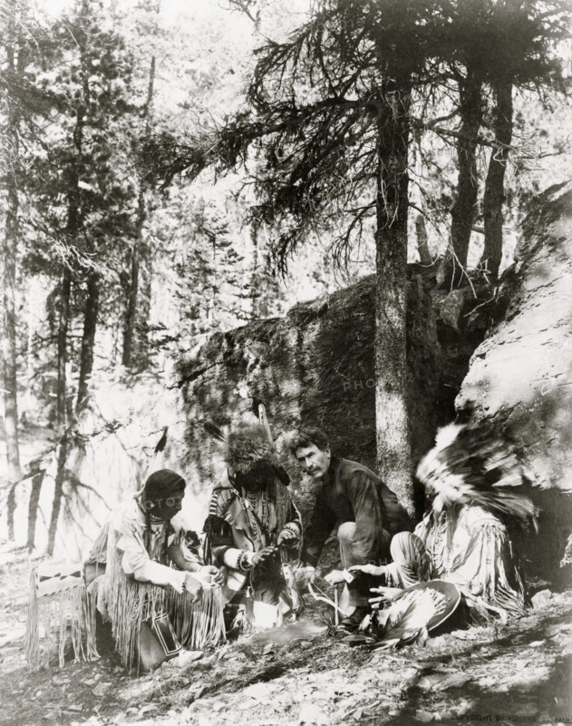 Ernest Thompson Seton, with three Blackfeet Indians, demonstrating how to start a fire 1917