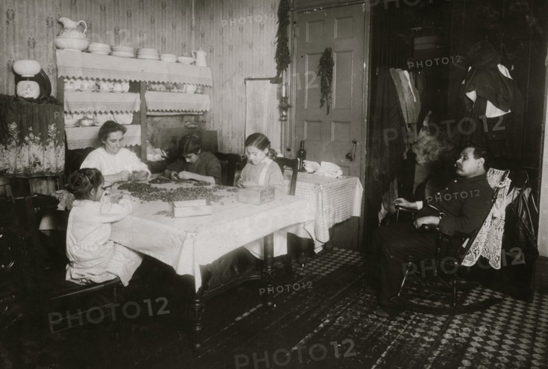 Italian Family picks nuts in their tenement apartment 1911