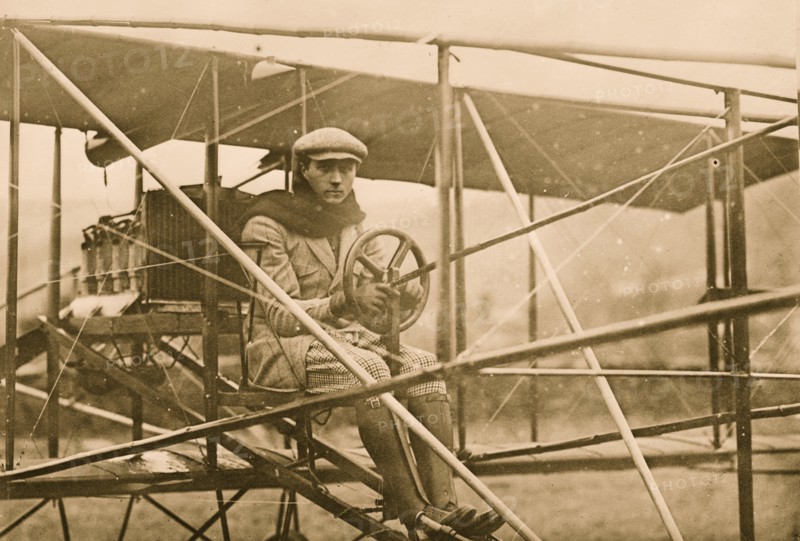 F.L. de Riemsdyk at pilot wheel of Curtiss aeroplane 1909