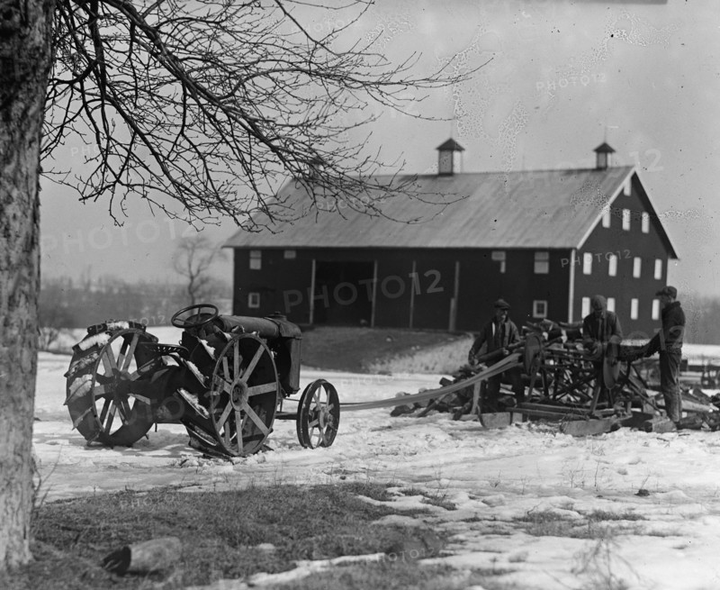 Farmer Drives Ford Tractor in yard 1924