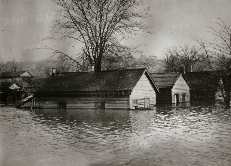 Floodwaters rise around a garage and home 1924