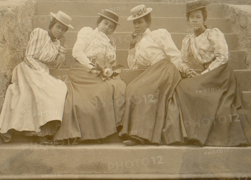 Four African American women seated on steps of building at Atlanta University, Georgia 1899