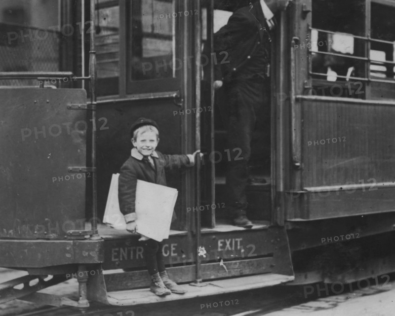 Francis Lance, 5 years old, 41 inches high. Sells regularly on Grand Avenue. He jumps on and off moving cars at risk of life. 1910