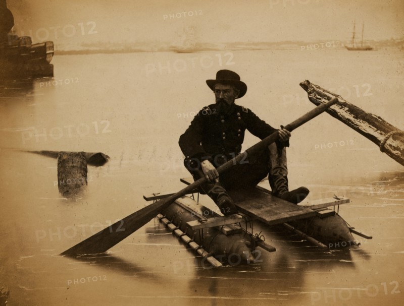 General Haupt rowing a boat made of a pair of small pontoons. 1863
