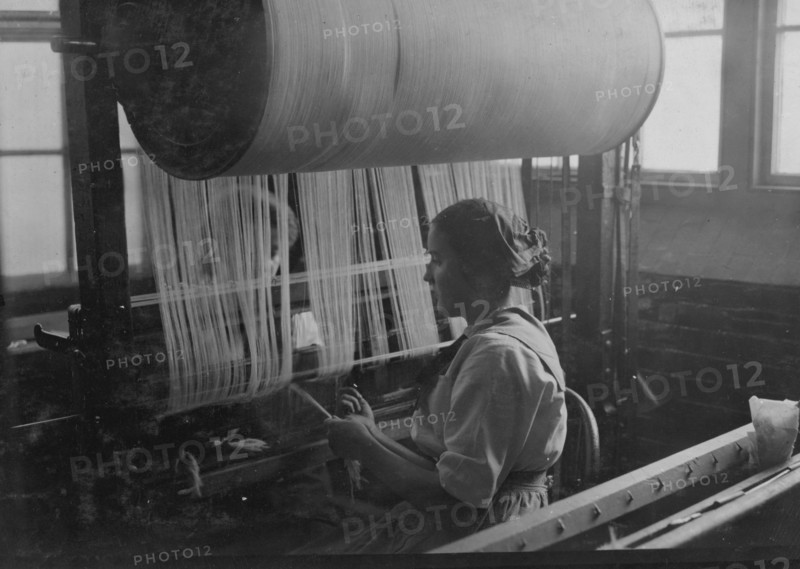 Girl at the drawing-in-frame of the weave-room, Lorraine Mills, Pawtucket, R.I.  1912