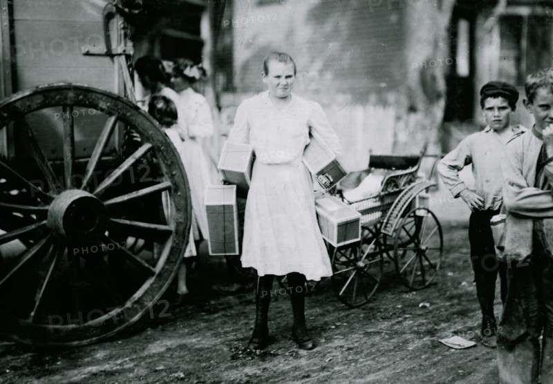 Girl with heavy load of tags. 1912