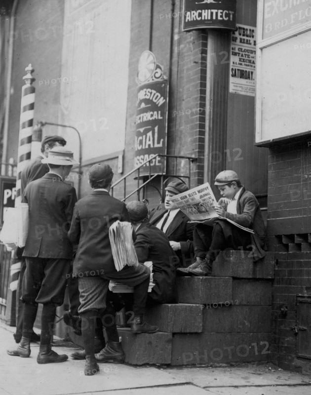 Group of newsboys on a stoop at 4th & Market Sts. Wilmington, DE 1910