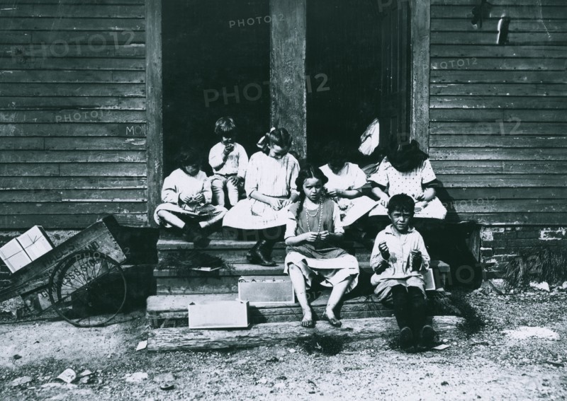 Group working on tags in rear of 196 Highland Street 1912