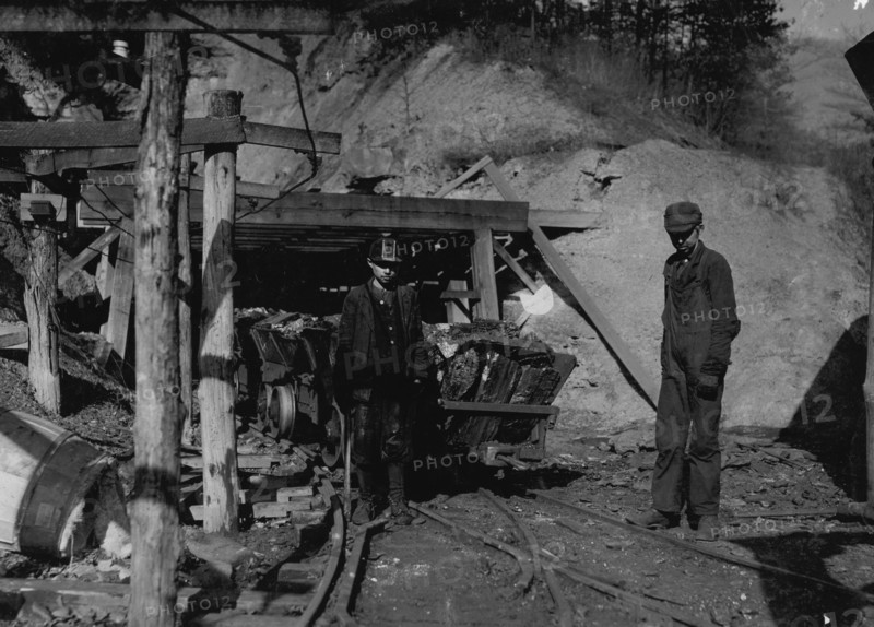 Hard work and dangerous for such a young boy. James O'Dell, a greaser and coupler on the tipple of the Cross Mountain Mine, Knoxville Iron Co., in the vicinity of Coal Creek, Tenn. James has been there four months. Helps push these heavily loaded cars. Appears to be about 12 or 13 years old.  1908