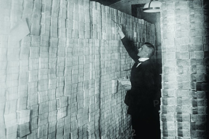 Inflation in Weimar Germany has paper money stacked from Floor to Ceiling in a Berlin Bank