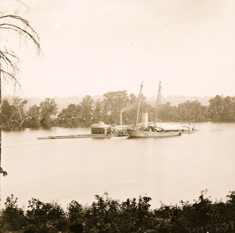 James River, Virginia. U.S. monitor CANONICUS taking on coal from a schooner 1864