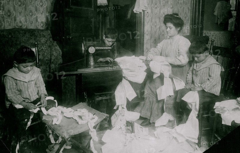 Making dresses for Campbell Kid Dolls in a dirty tenement room 1912