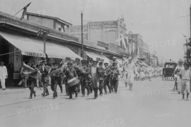 Mexican Band Plays Instruments in front of Marching Columns of US Navy Sailors