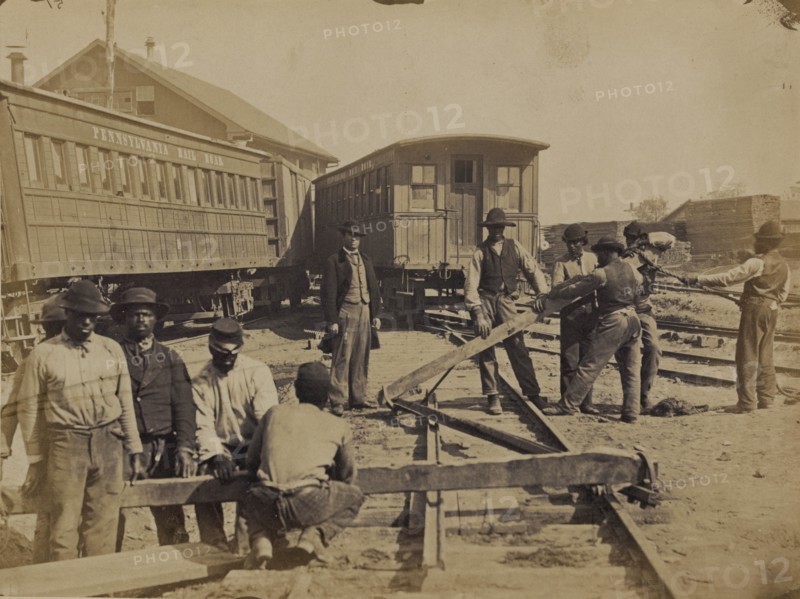 Military railroad operations in northern Virginia: men using levers for loosening rails 1863