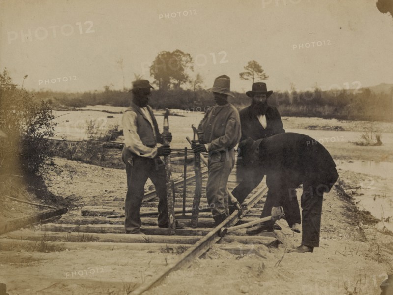 Military railroad operations in northern Virginia: men using levers for loosening rails 1863