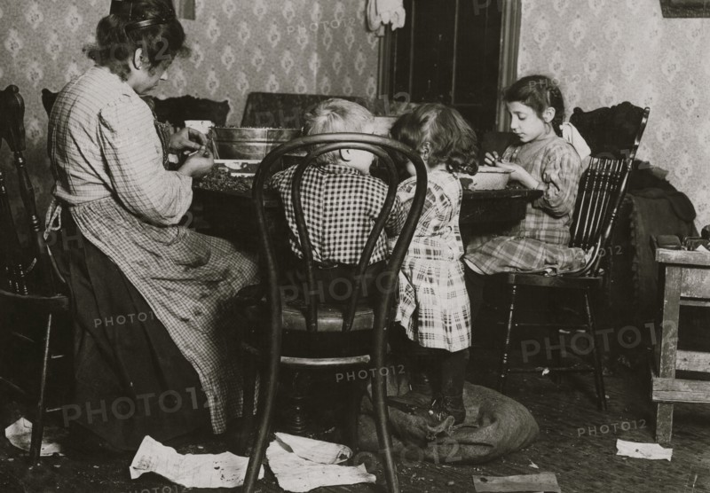Italian Family picks nuts in their tenement apartment 1911