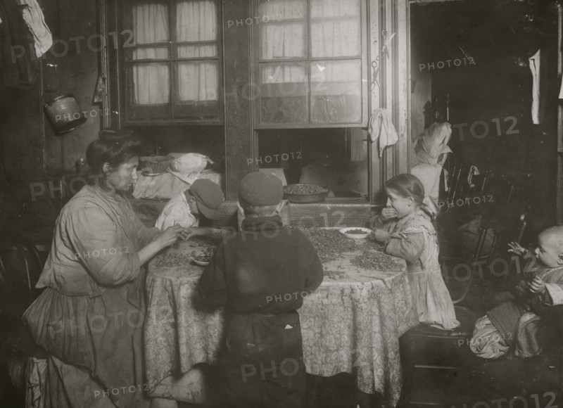 Italian family packing nuts in their tenement apartment 1911