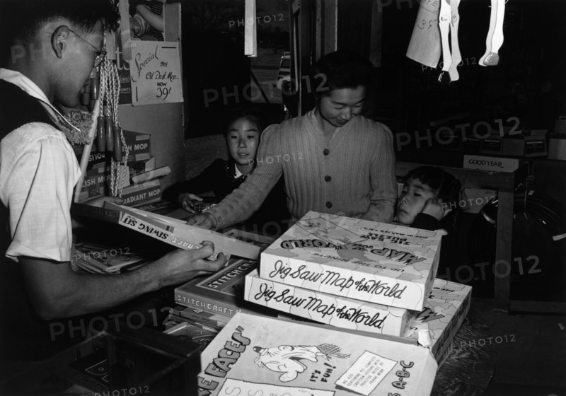 Mrs. Yaeko Nakamura and family buying toys with Fred Moriguchi 1943