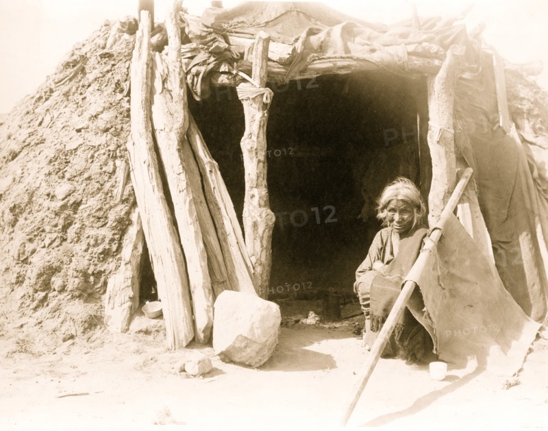 Old Navajo Indian seated in doorway of hogan 1901